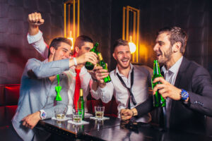 group of men toasting to each other at bachelor party