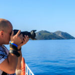 photographer taking photo on deck of yacht