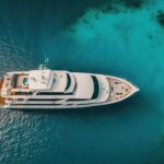 Top view on luxury yacht in paradise turquoise ocean water. Generative AI.