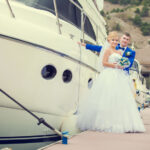Beautiful bride and groom wedding couple near sea yacht