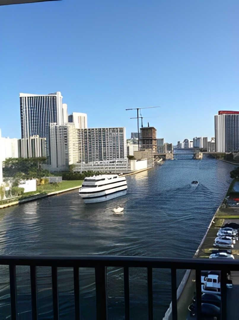 A Scenic View of the Water From a Miami Balcony, Showcasing the Vibrant Blue Waves and Clear Sky.